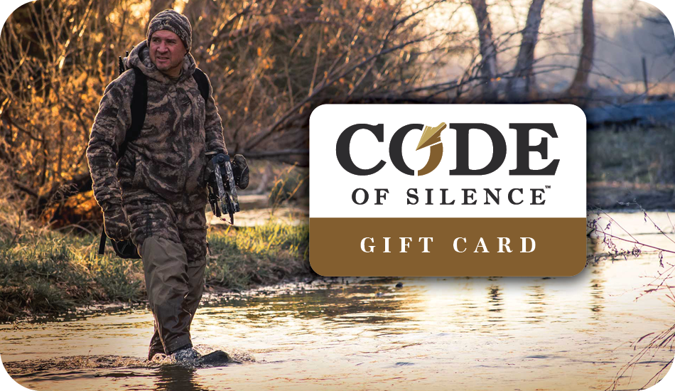Code of Silence gift card showing a hunter in camo wading a shallow creek at sunrise